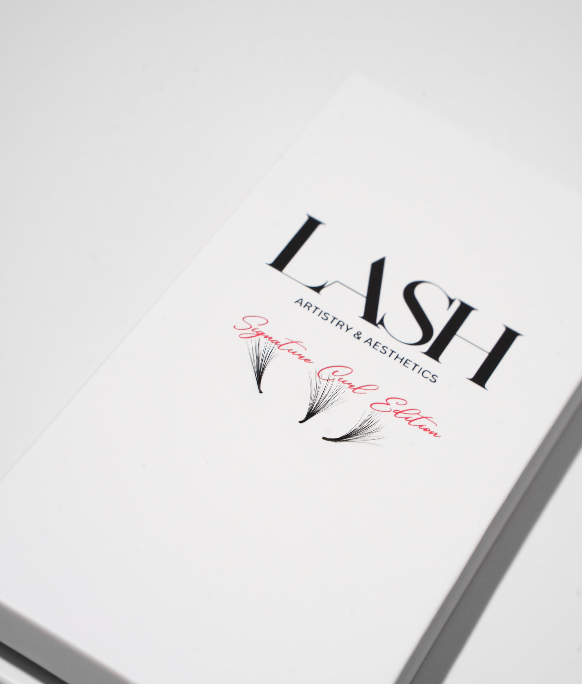 Product packaging for 'LASH Artistry & Aesthetics' with decorative elements on a white background