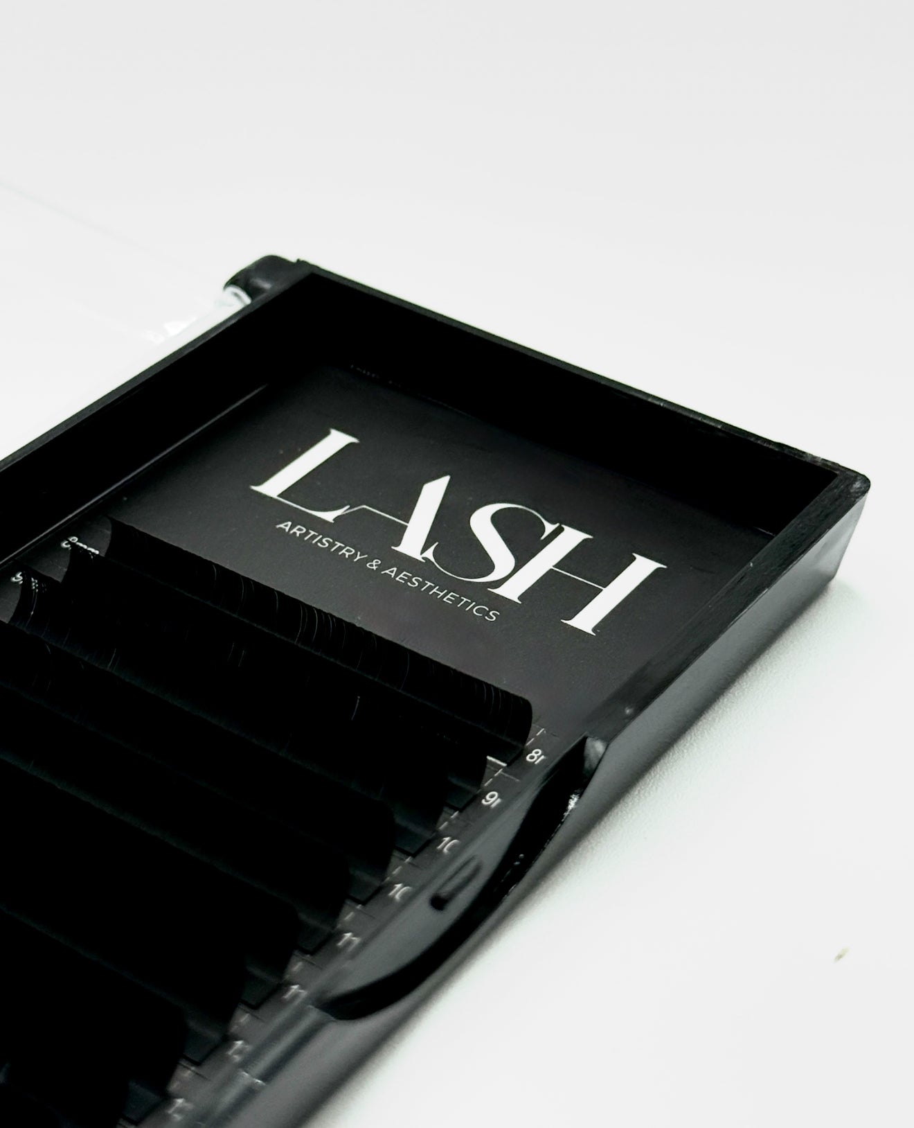 Black tray with 'LASH Artistry & Aesthetics' branding on a white background