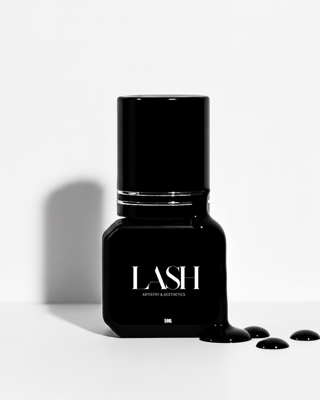 Black nail polish bottle with 'LASH' branding on a white background