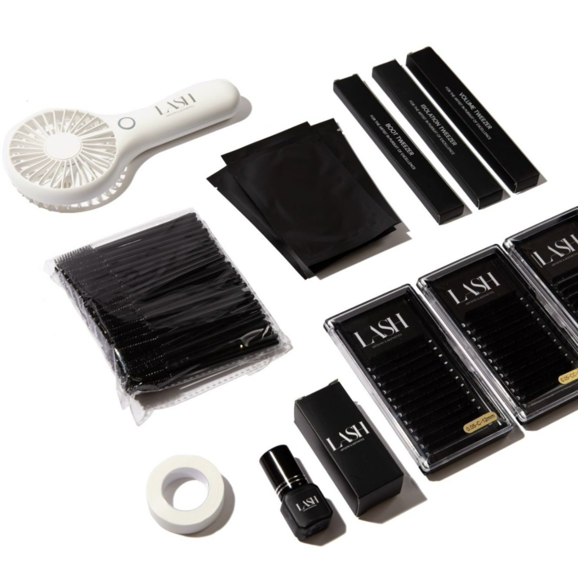 A collection of cosmetic tools and false eyelashes laid out on a white background, including lash trays, tweezers, glue, a fan brush, and individual eyelashes.